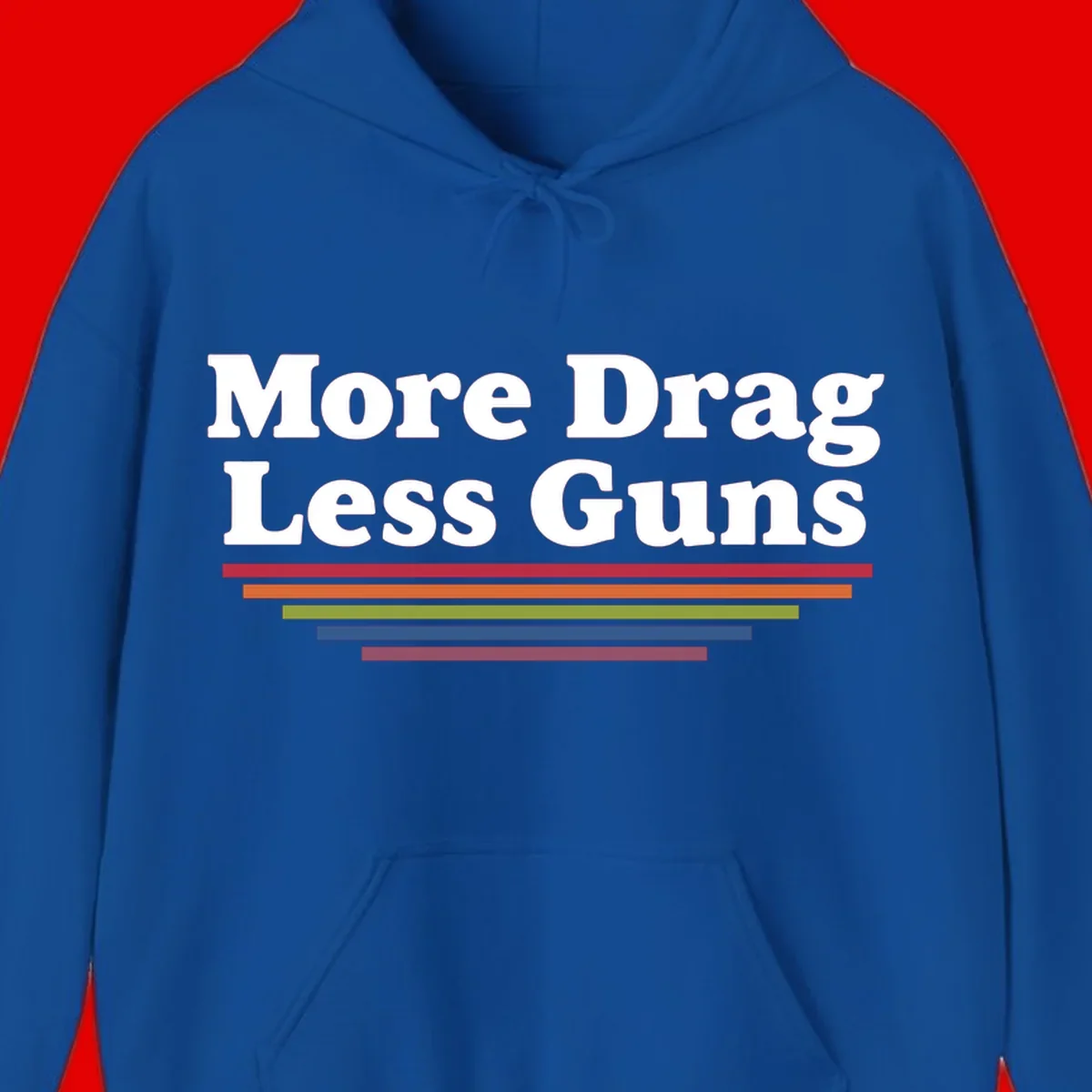 Bold white text reading 'More Drag Less Guns' with colorful horizontal bars below on gray background