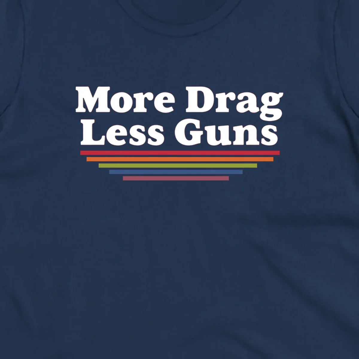 Bold white text reading 'More Drag Less Guns' with colorful horizontal bars below on gray background