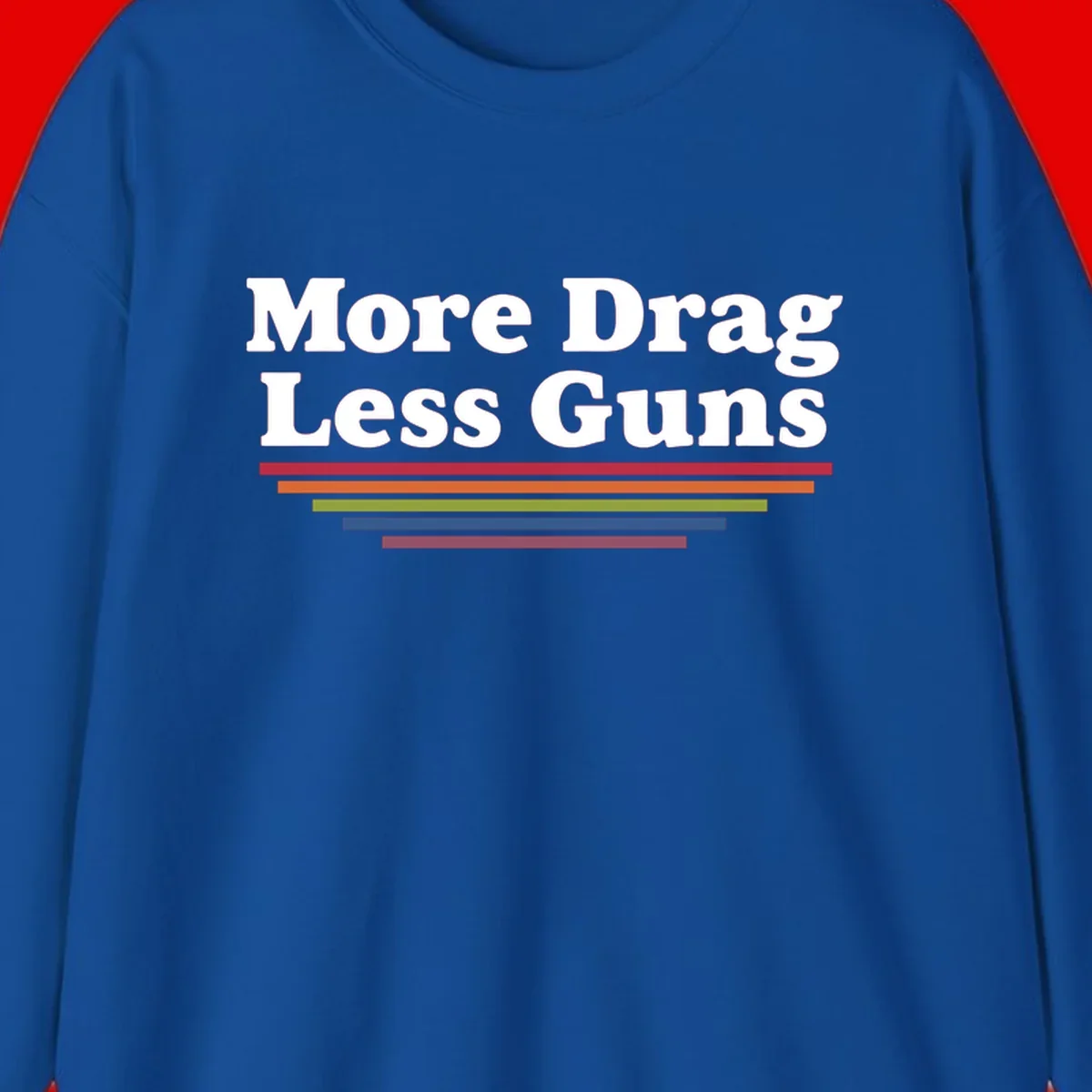 Bold white text reading 'More Drag Less Guns' with colorful horizontal bars below on gray background