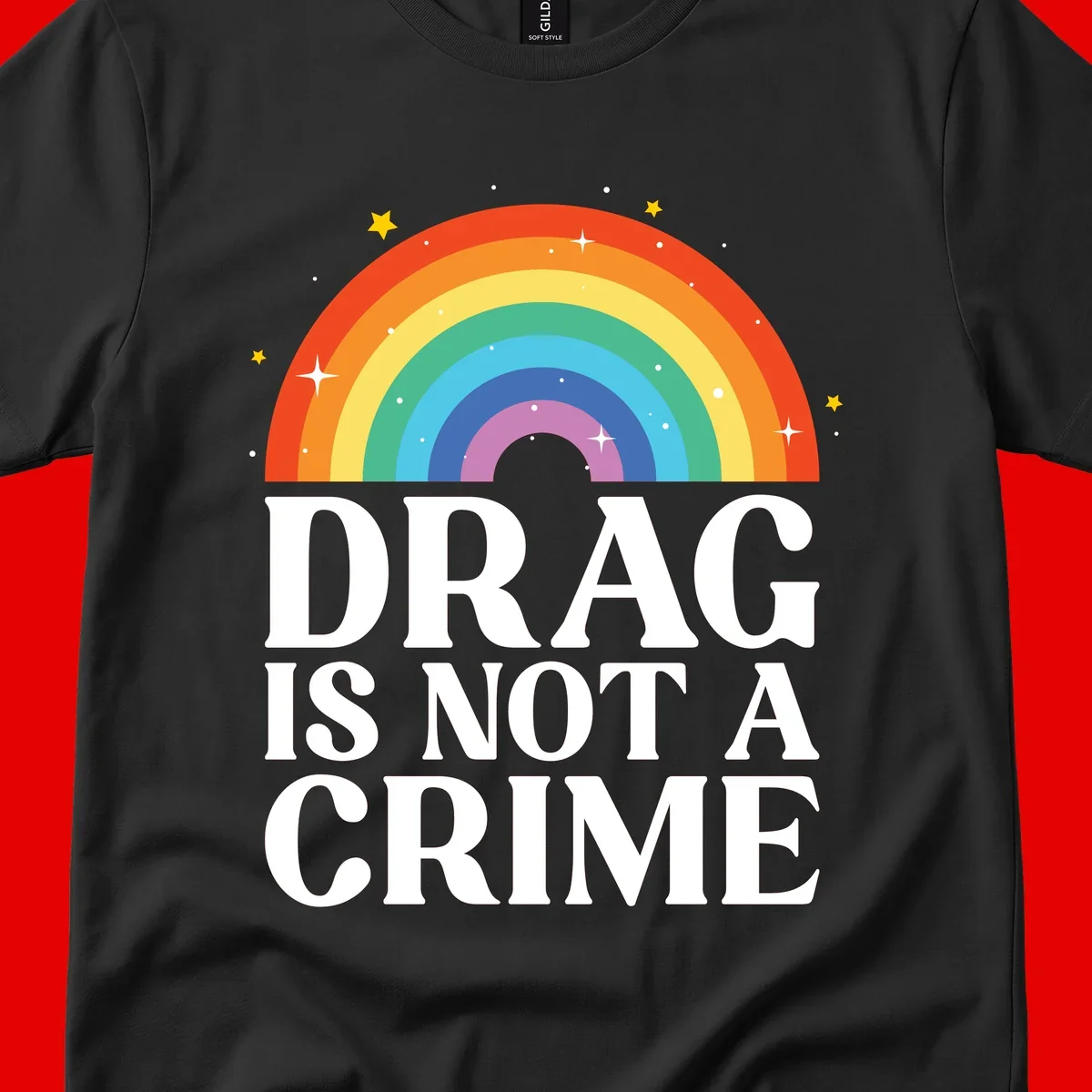 Rainbow arc with stars and text reading 'Drag Is Not A Crime' - a pride-themed design celebrating drag rights and LGBTQ+ equality