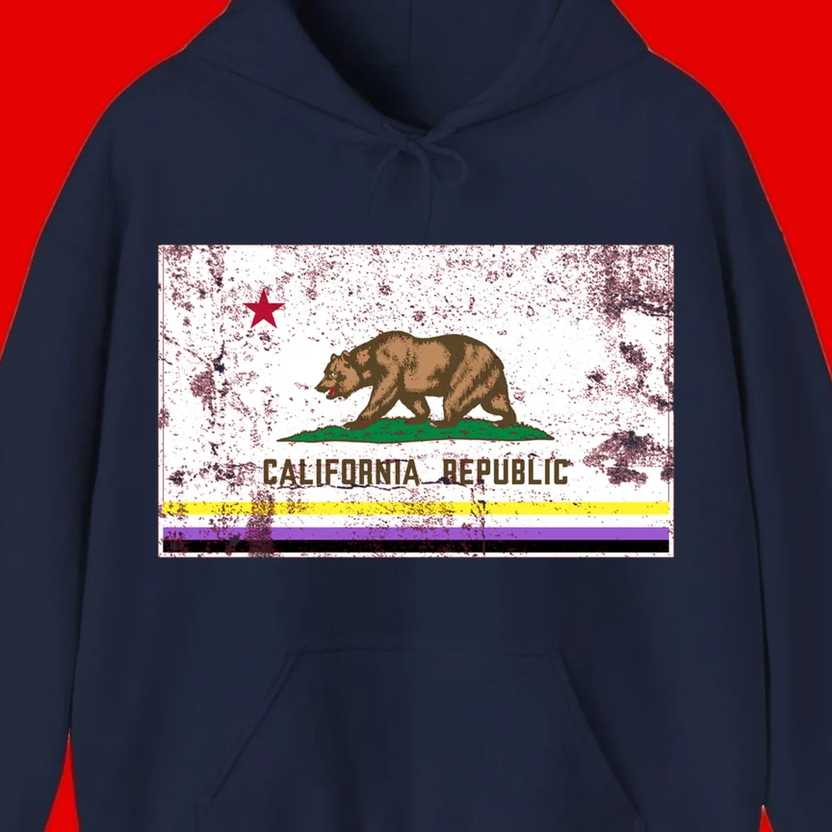 Vintage distressed California Republic bear design with red star, standing on green grass, with yellow, purple, and black pride flag stripes below