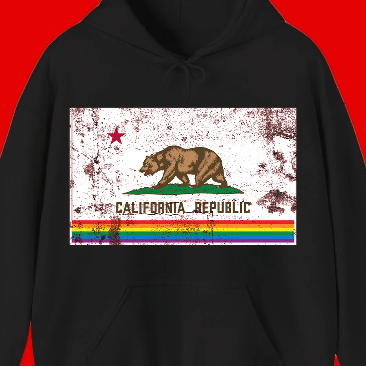 Distressed vintage California Republic flag bear with raised paw on green grass, red star above, CALIFORNIA REPUBLIC text, and rainbow pride stripes below