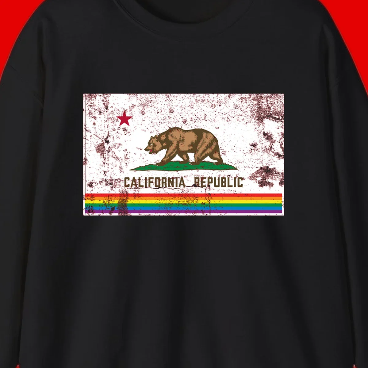 Distressed vintage California Republic flag bear with raised paw on green grass, red star above, CALIFORNIA REPUBLIC text, and rainbow pride stripes below