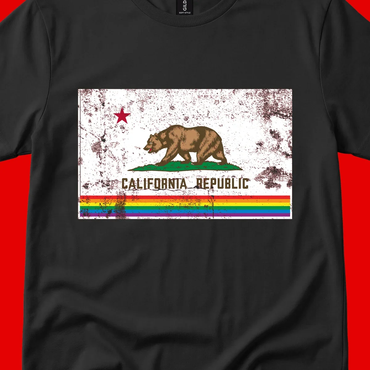 Distressed vintage California Republic flag bear with raised paw on green grass, red star above, CALIFORNIA REPUBLIC text, and rainbow pride stripes below