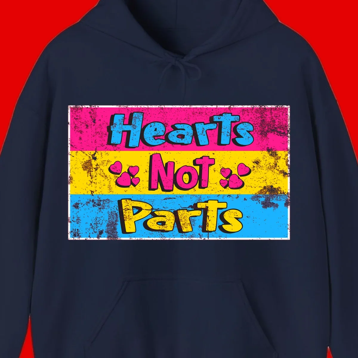 Hearts Not Parts design: magenta, yellow, and blue color-blocked graphic with distressed typography and pink hearts celebrating trans and non-binary identity