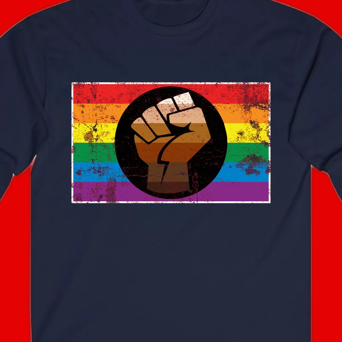 Distressed circular badge featuring a raised brown fist overlaid on a rainbow pride flag background, symbolizing LGBTQ+ solidarity and empowerment