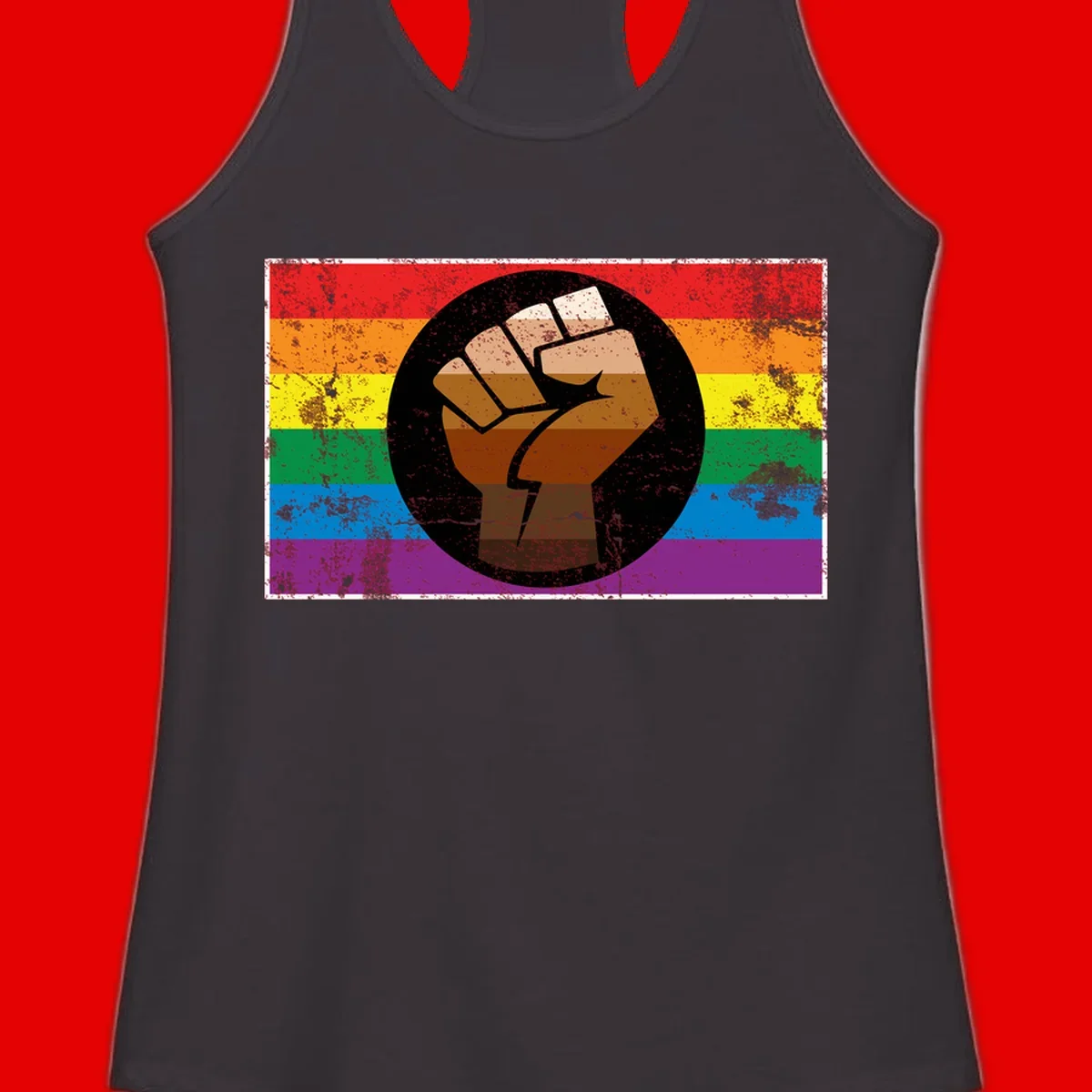 Distressed circular badge featuring a raised brown fist overlaid on a rainbow pride flag background, symbolizing LGBTQ+ solidarity and empowerment