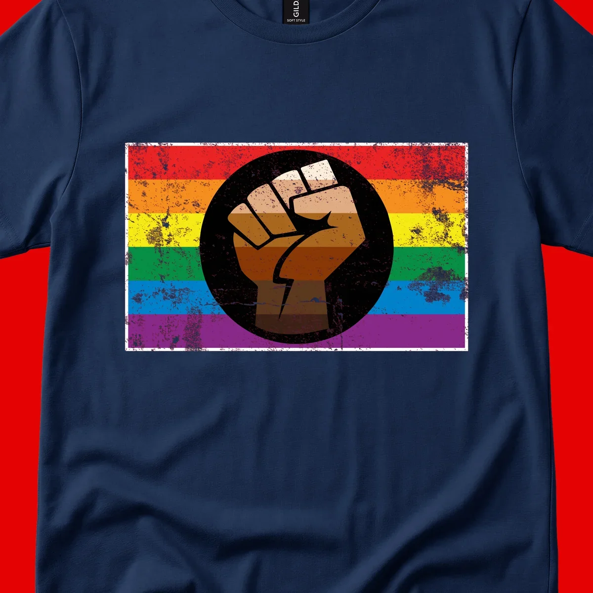 Distressed circular badge featuring a raised brown fist overlaid on a rainbow pride flag background, symbolizing LGBTQ+ solidarity and empowerment