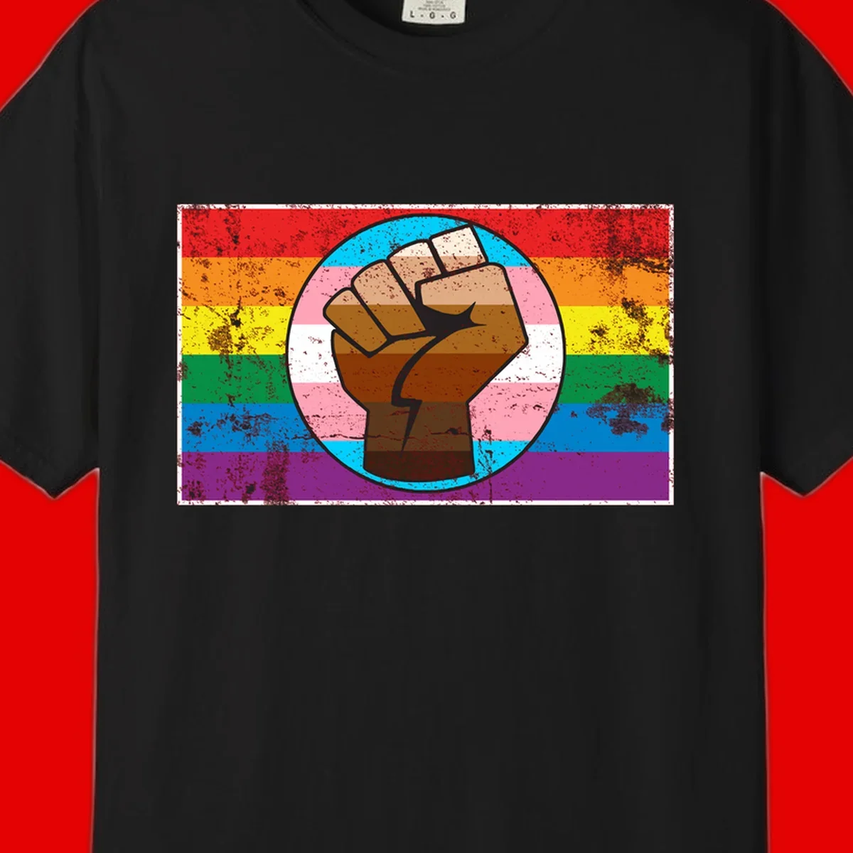 Raised brown fist in circular badge with rainbow pride flag and trans flag stripe background symbolizing LGBTQ+ solidarity