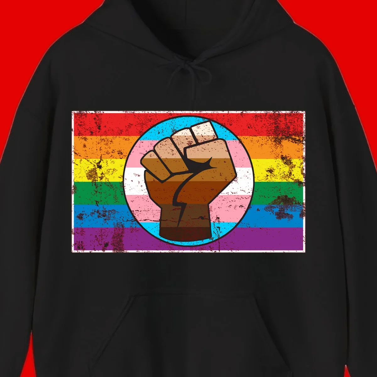 Raised brown fist in circular badge with rainbow pride flag and trans flag stripe background symbolizing LGBTQ+ solidarity