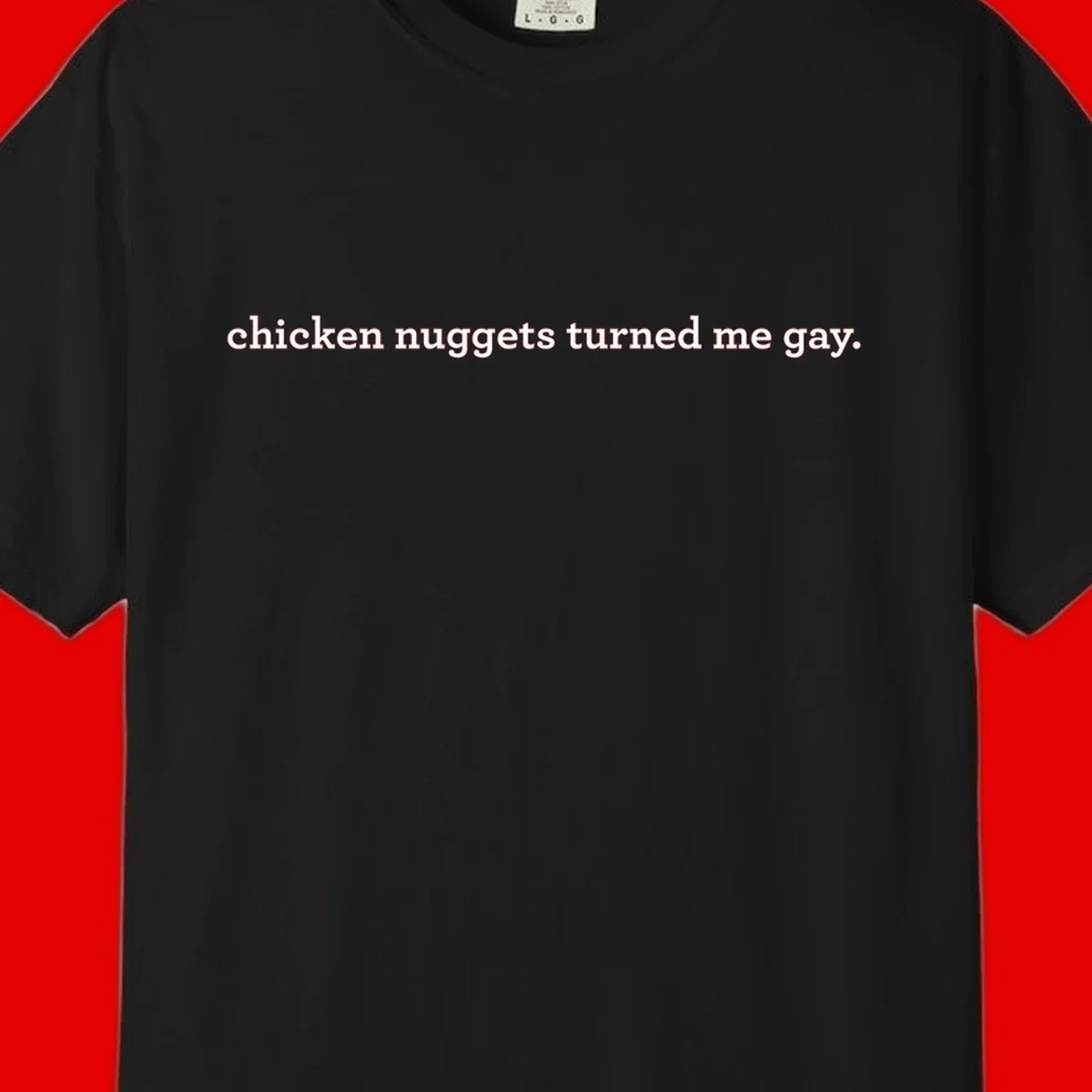 White text reading 'chicken nuggets turned me gay' on gray background - humorous pride design
