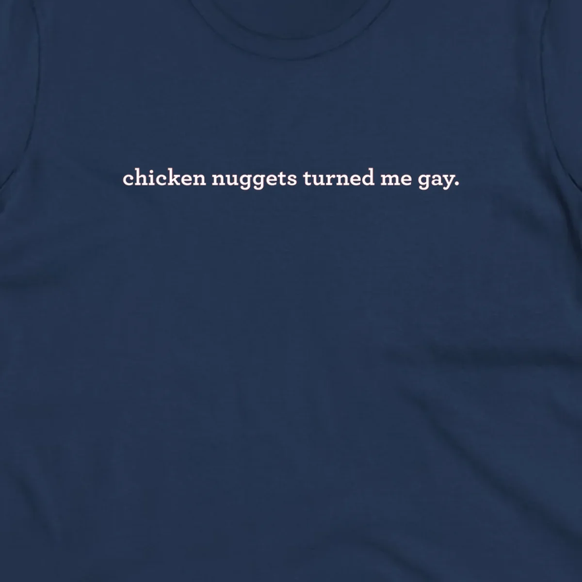 White text reading 'chicken nuggets turned me gay' on gray background - humorous pride design