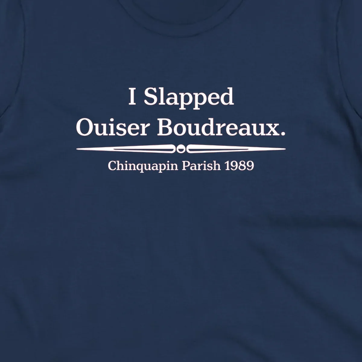 White text on gray background reading 'I Slapped Ouiser Boudreaux. Chinquapin Parish 1989' with decorative line divider