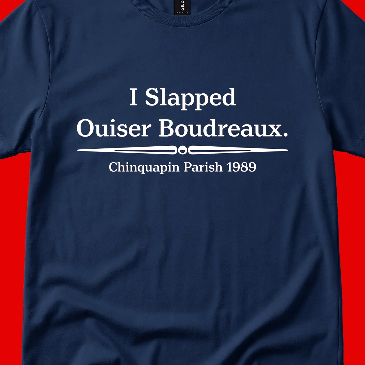 White text on gray background reading 'I Slapped Ouiser Boudreaux. Chinquapin Parish 1989' with decorative line divider