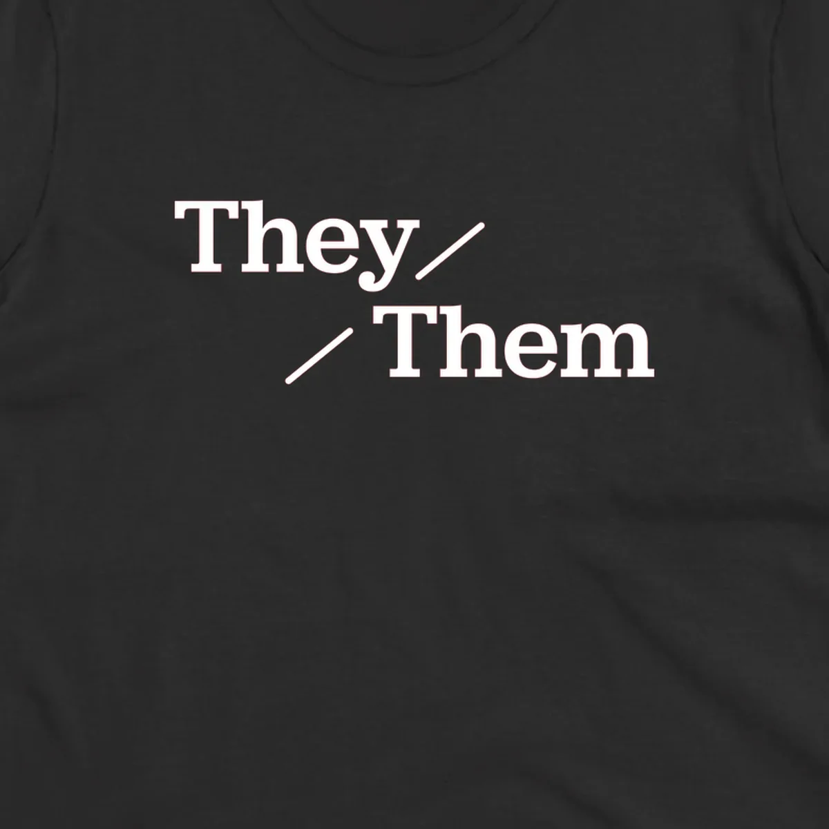 Minimalist design with white text reading 'They / Them' on gray background, celebrating gender-inclusive pronouns
