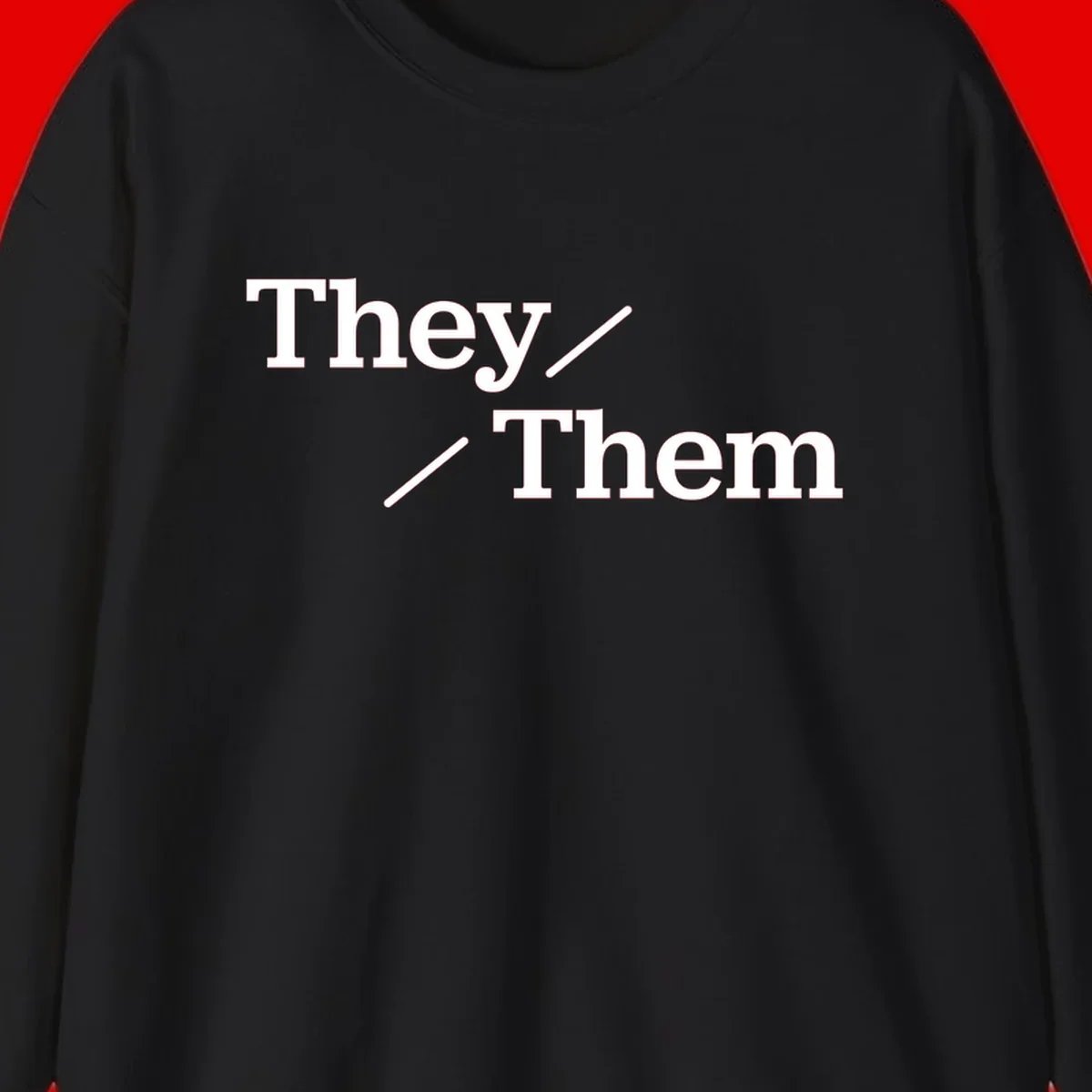 Minimalist design with white text reading 'They / Them' on gray background, celebrating gender-inclusive pronouns