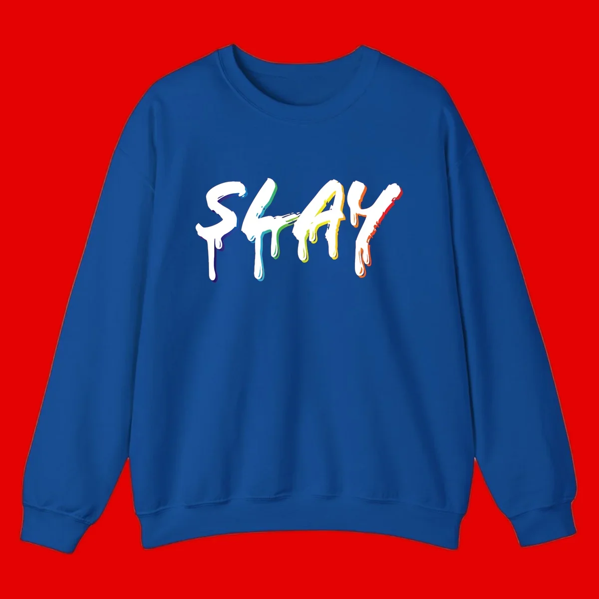 The word STAY in white letters with rainbow pride-colored paint drips flowing downward, featuring blue, teal, green, yellow, orange, and red colors on gray background