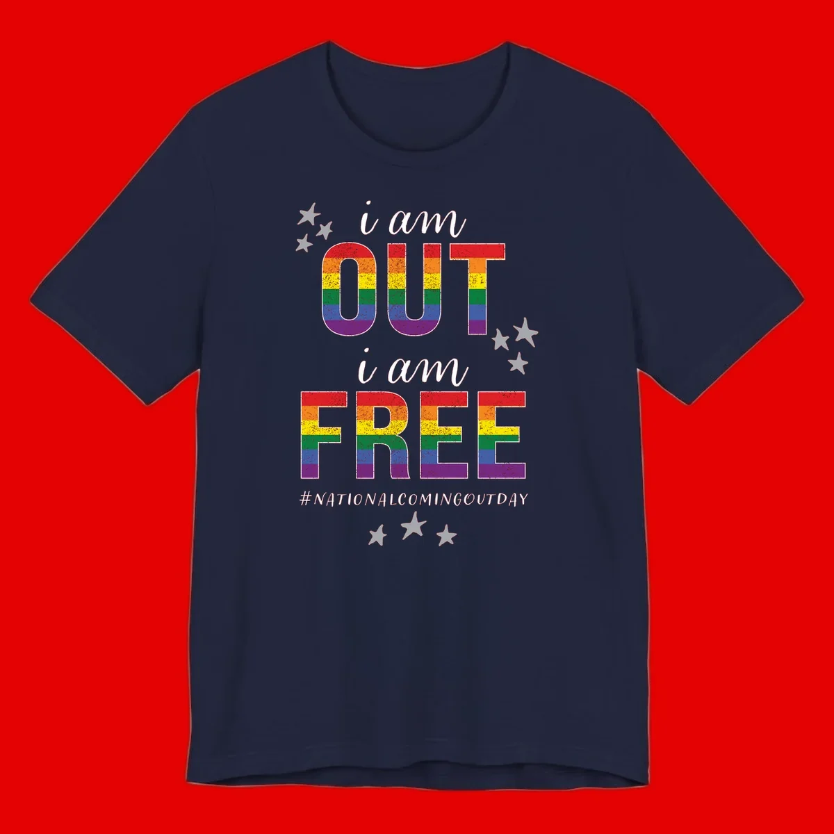 Rainbow-striped letters spelling 'i am OUT i am FREE' with decorative stars on gray background celebrating National Coming Out Day pride.
