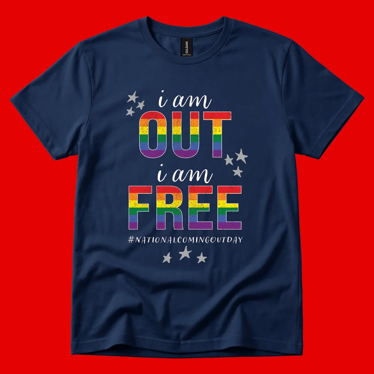 Rainbow-striped letters spelling 'i am OUT i am FREE' with decorative stars on gray background celebrating National Coming Out Day pride.
