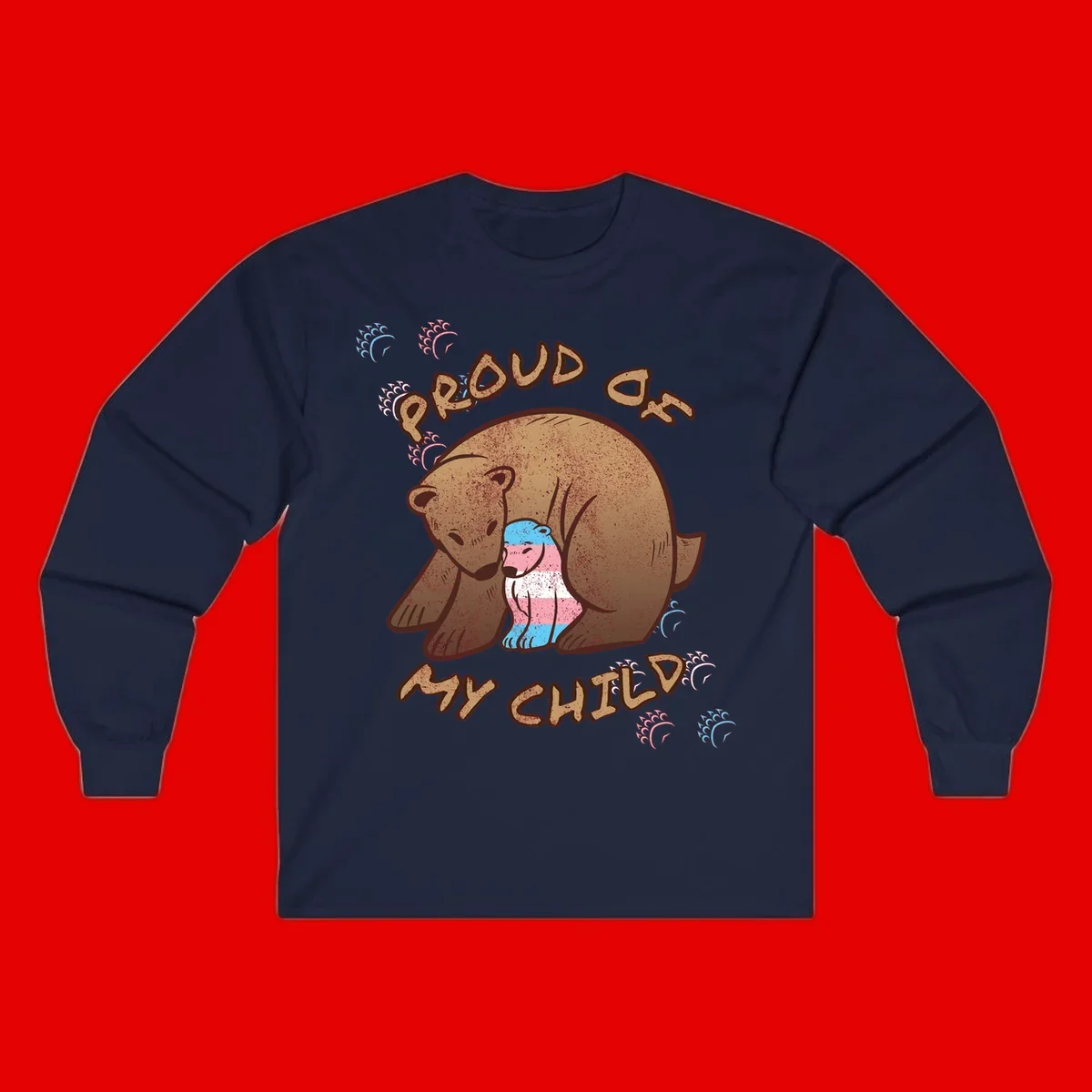Brown bear holding a cub with blue, pink and white stripes, surrounded by 'Proud As My Chubby' text and decorative wave designs celebrating transgender pride
