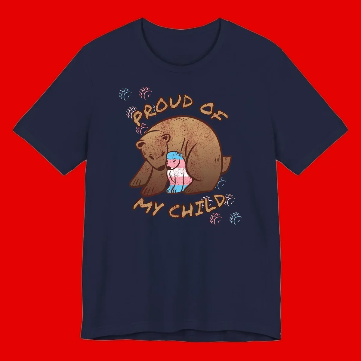 Brown bear holding a cub with blue, pink and white stripes, surrounded by 'Proud As My Chubby' text and decorative wave designs celebrating transgender pride