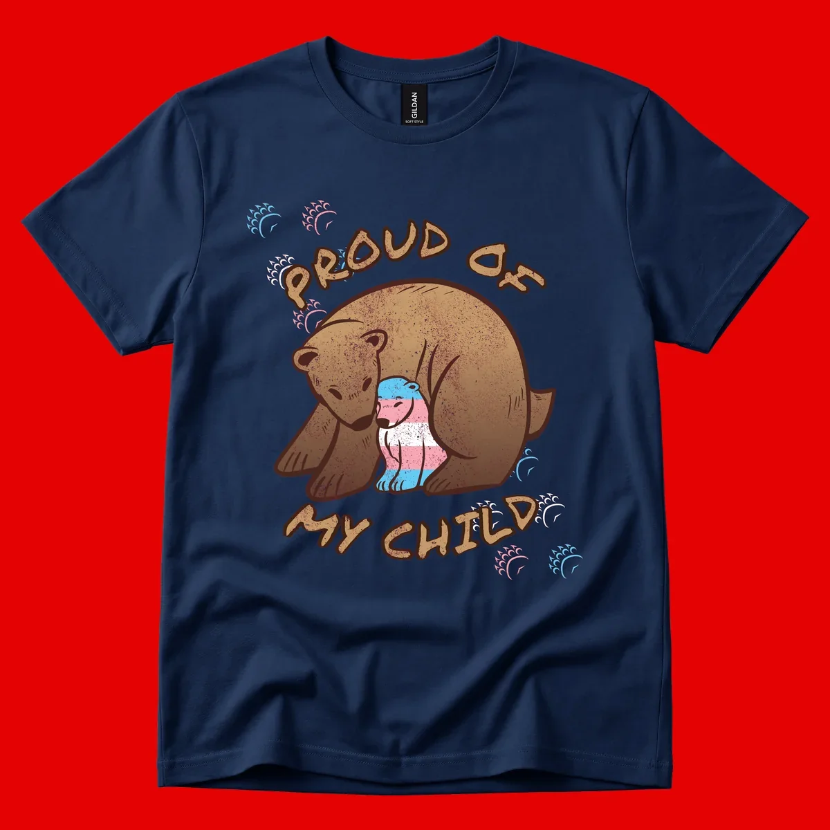 Brown bear holding a cub with blue, pink and white stripes, surrounded by 'Proud As My Chubby' text and decorative wave designs celebrating transgender pride