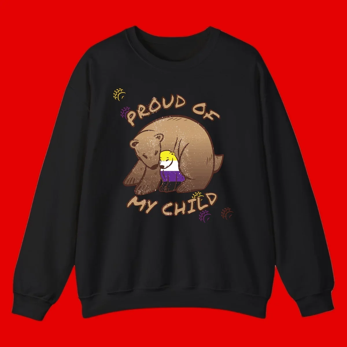 Illustration of a large brown bear's head in profile containing a small figure wearing pride flag colors, with text reading 'Proud As Child'