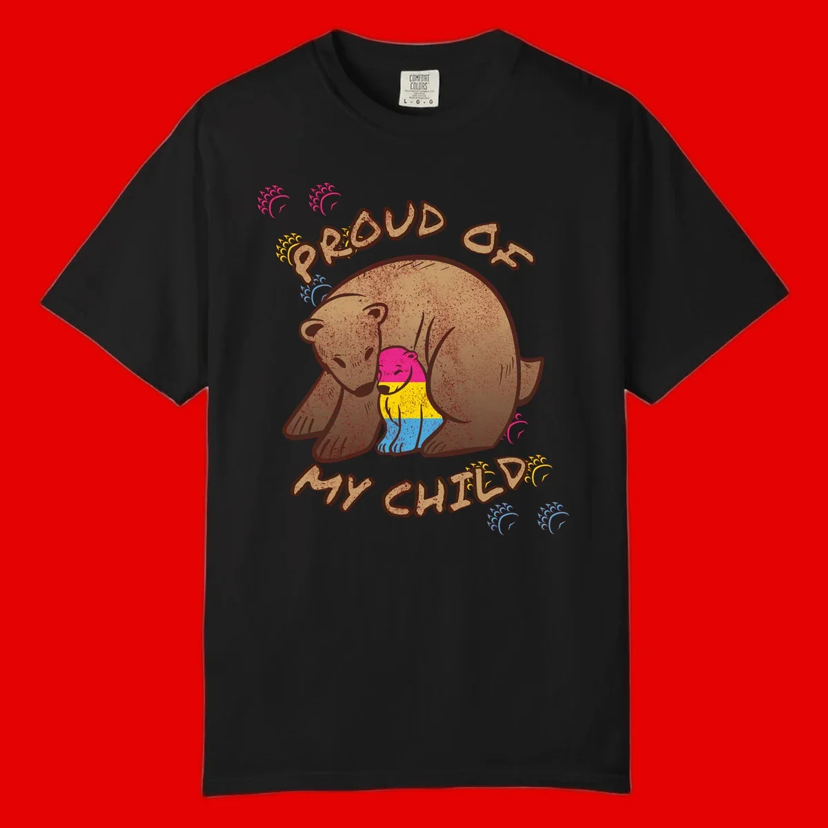 Large bear proudly hugging a smaller bear cub wearing a pride flag shirt, with text reading 'Proud As My Child'