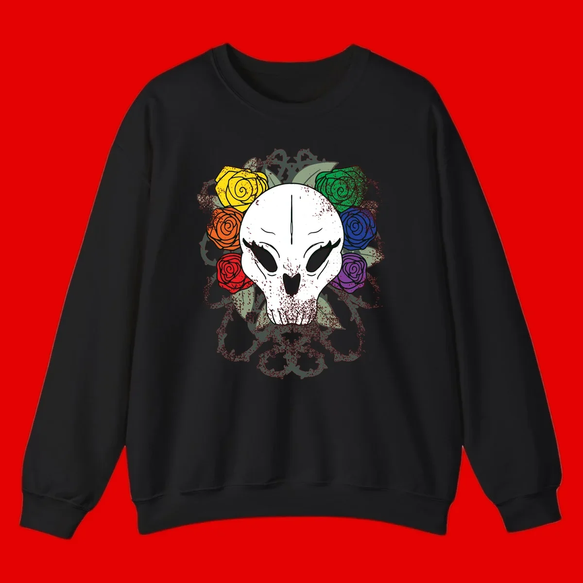 White skull with rainbow colored roses in yellow, orange, red, blue, green, and purple surrounding it on gray background