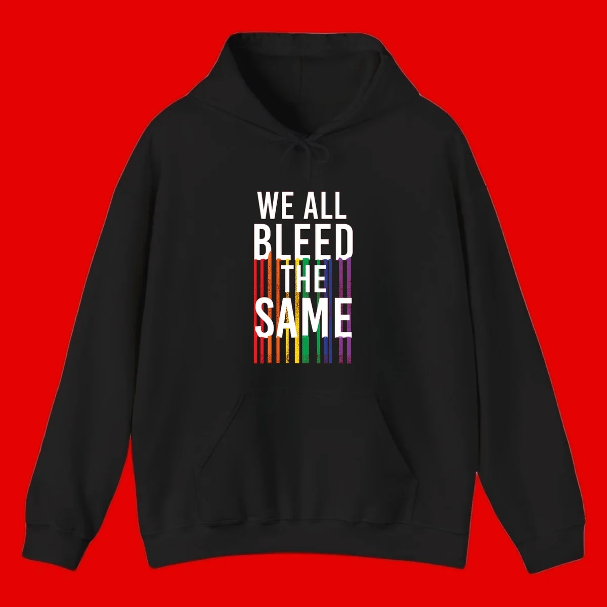 White bold text 'We All Bleed The Same' over rainbow vertical stripes in pride flag colors on gray background