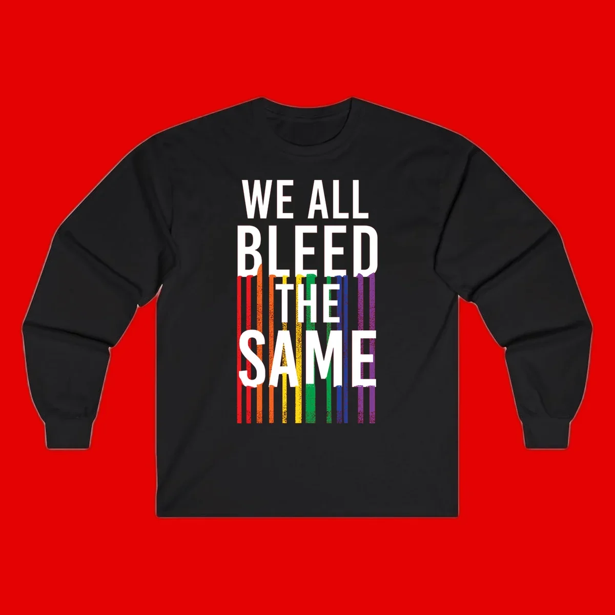 White bold text 'We All Bleed The Same' over rainbow vertical stripes in pride flag colors on gray background