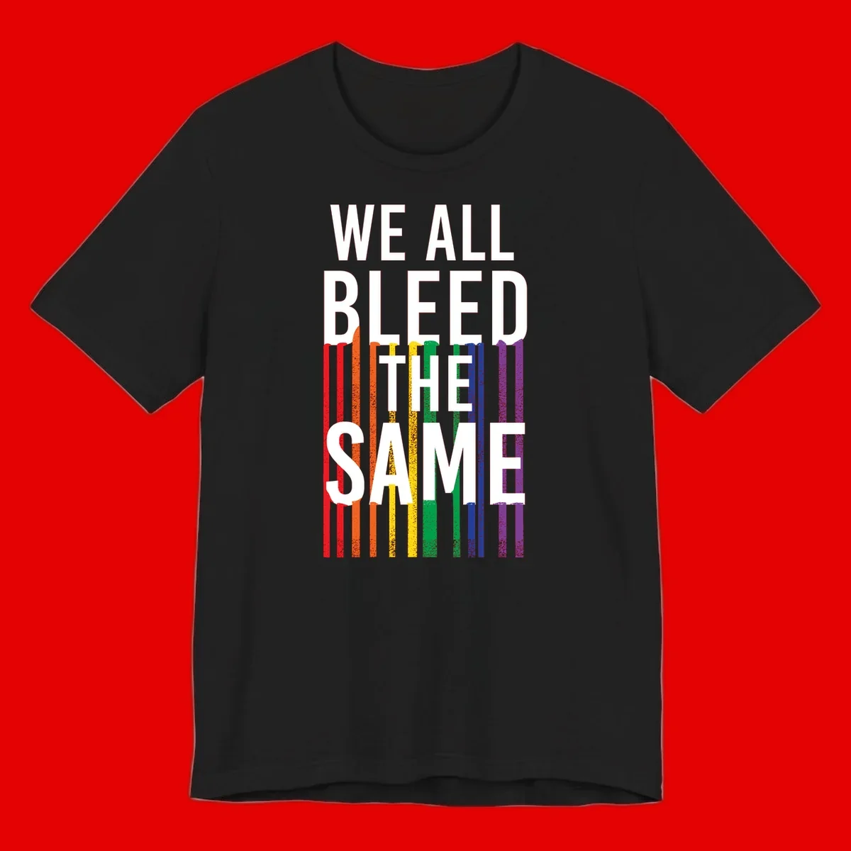 White bold text 'We All Bleed The Same' over rainbow vertical stripes in pride flag colors on gray background