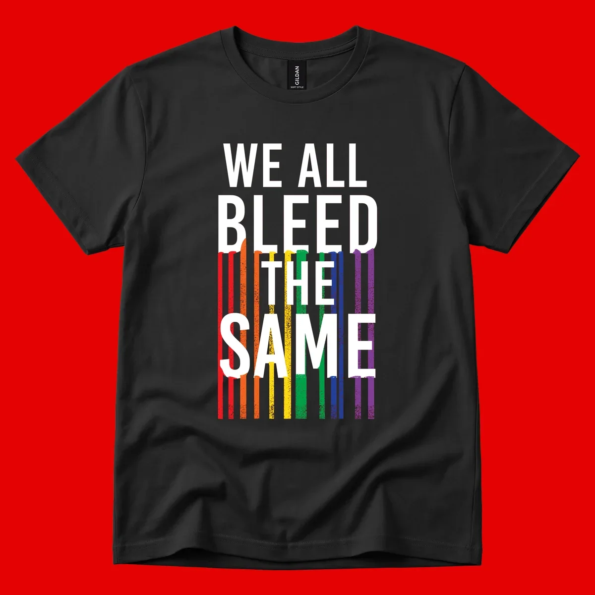 White bold text 'We All Bleed The Same' over rainbow vertical stripes in pride flag colors on gray background