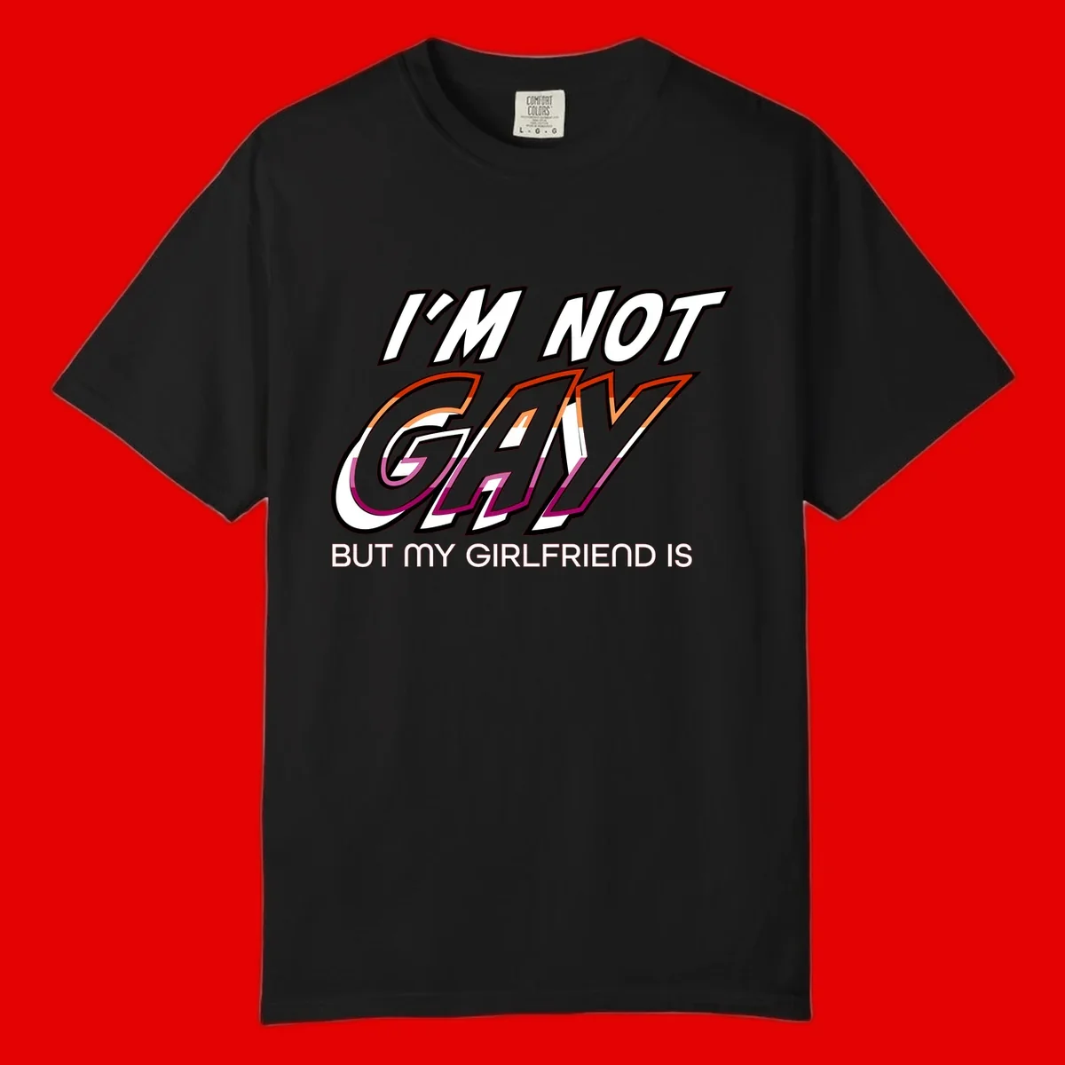 Bold typography design reading 'I'm not gay but my girlfriend is' in orange and magenta layered 3D letters
