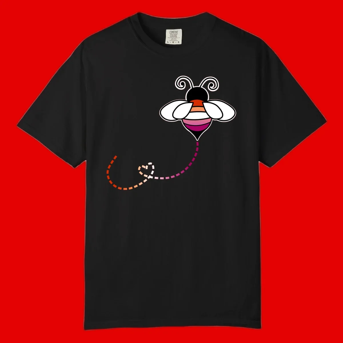 Illustrated rainbow pride bee with spiral antennae, white wings, and colorful striped body with dotted flight path