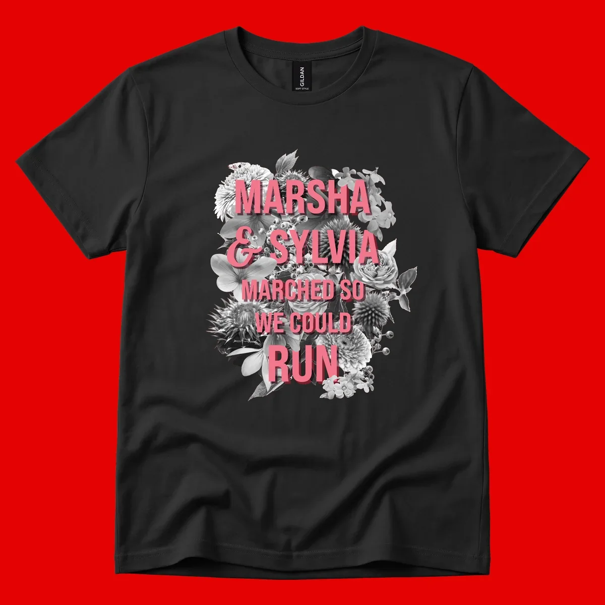 Pink text reading 'Marsha & Sylvia Marched So We Could Run' overlaid on black and white floral arrangement with roses and dahlias