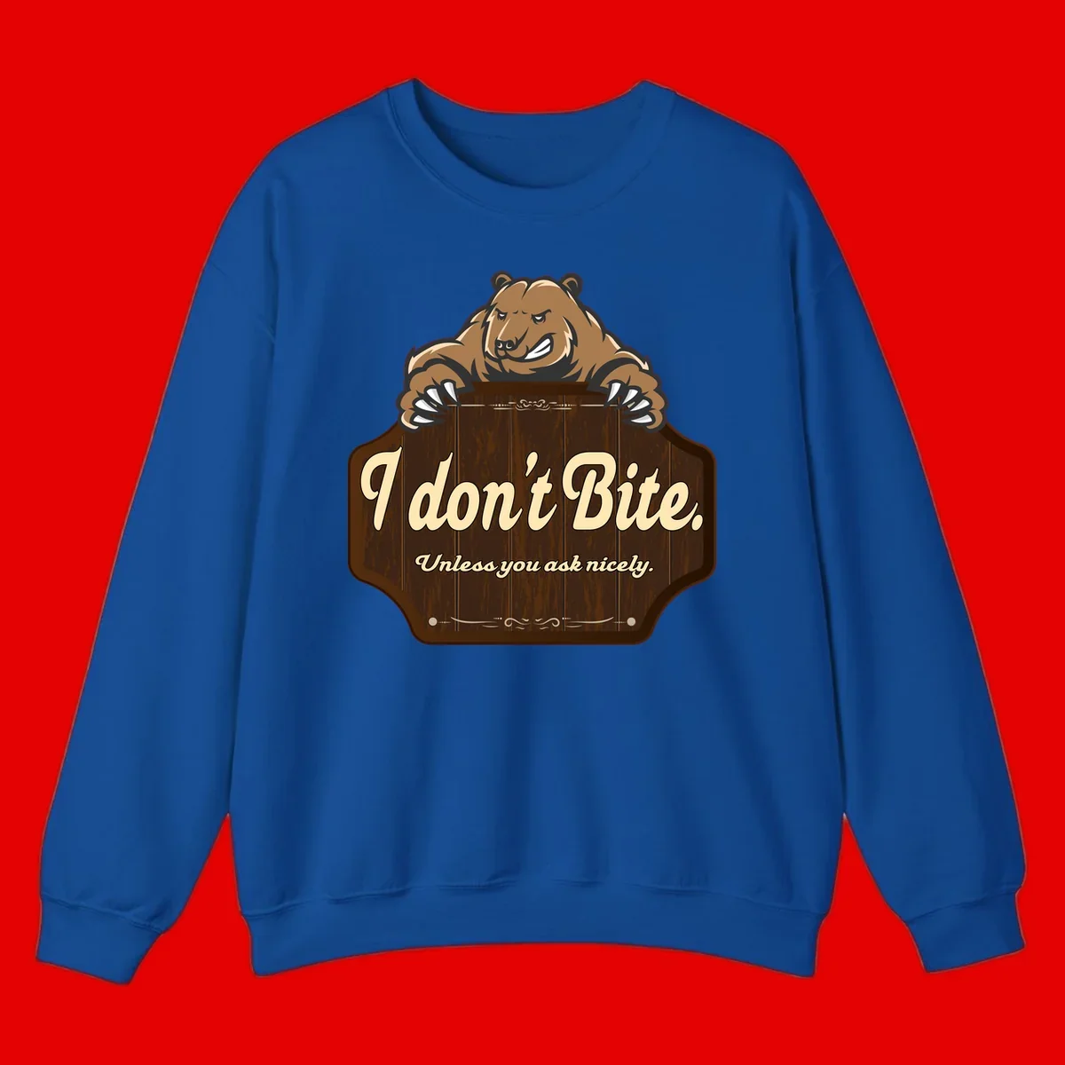 Brown grizzly bear grinning mischievously while holding a wooden sign reading 'I don't Bite. Unless you ask nicely' with decorative vintage styling