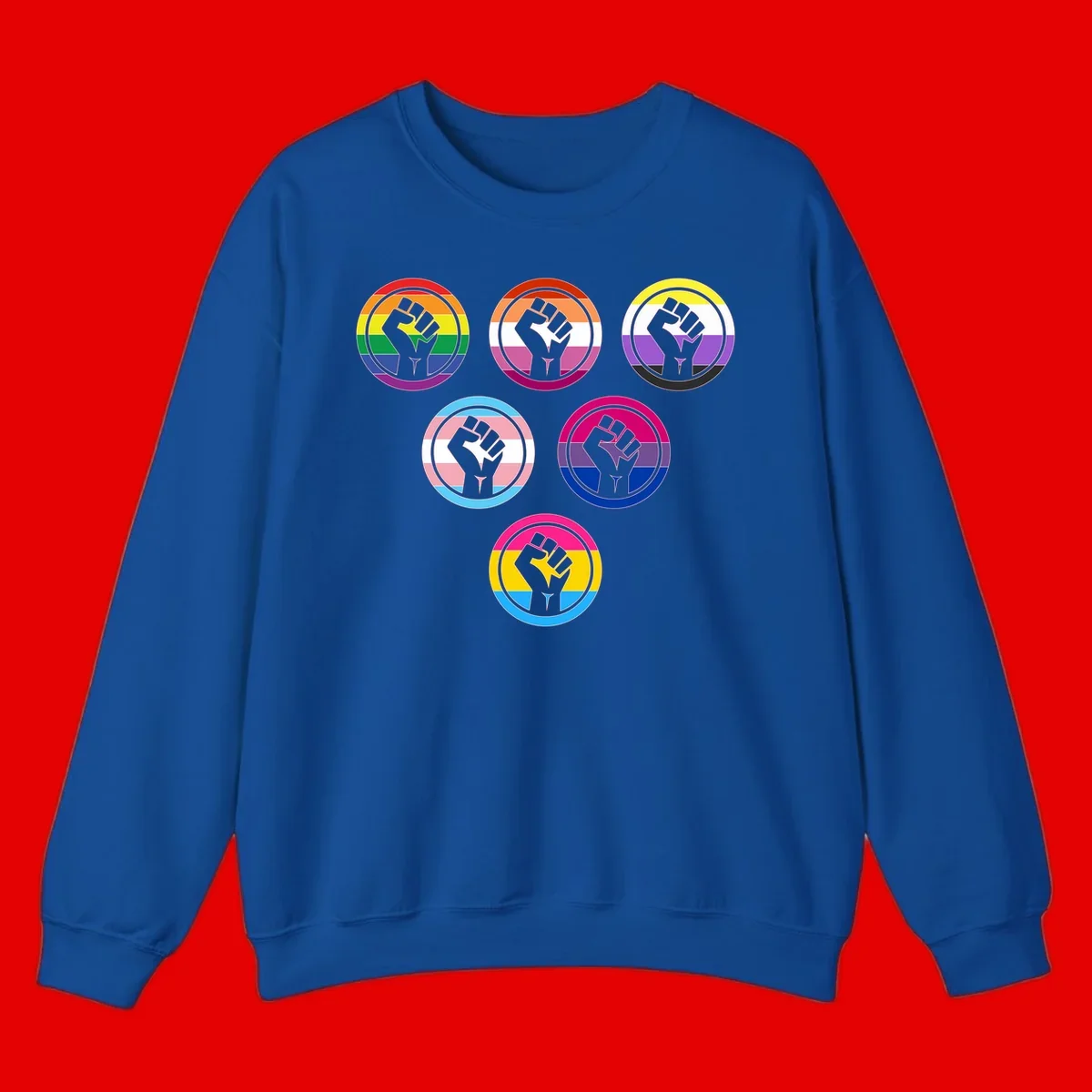 Six circular badge designs with raised fist symbols in different pride flag color schemes including rainbow, trans, and pansexual flags