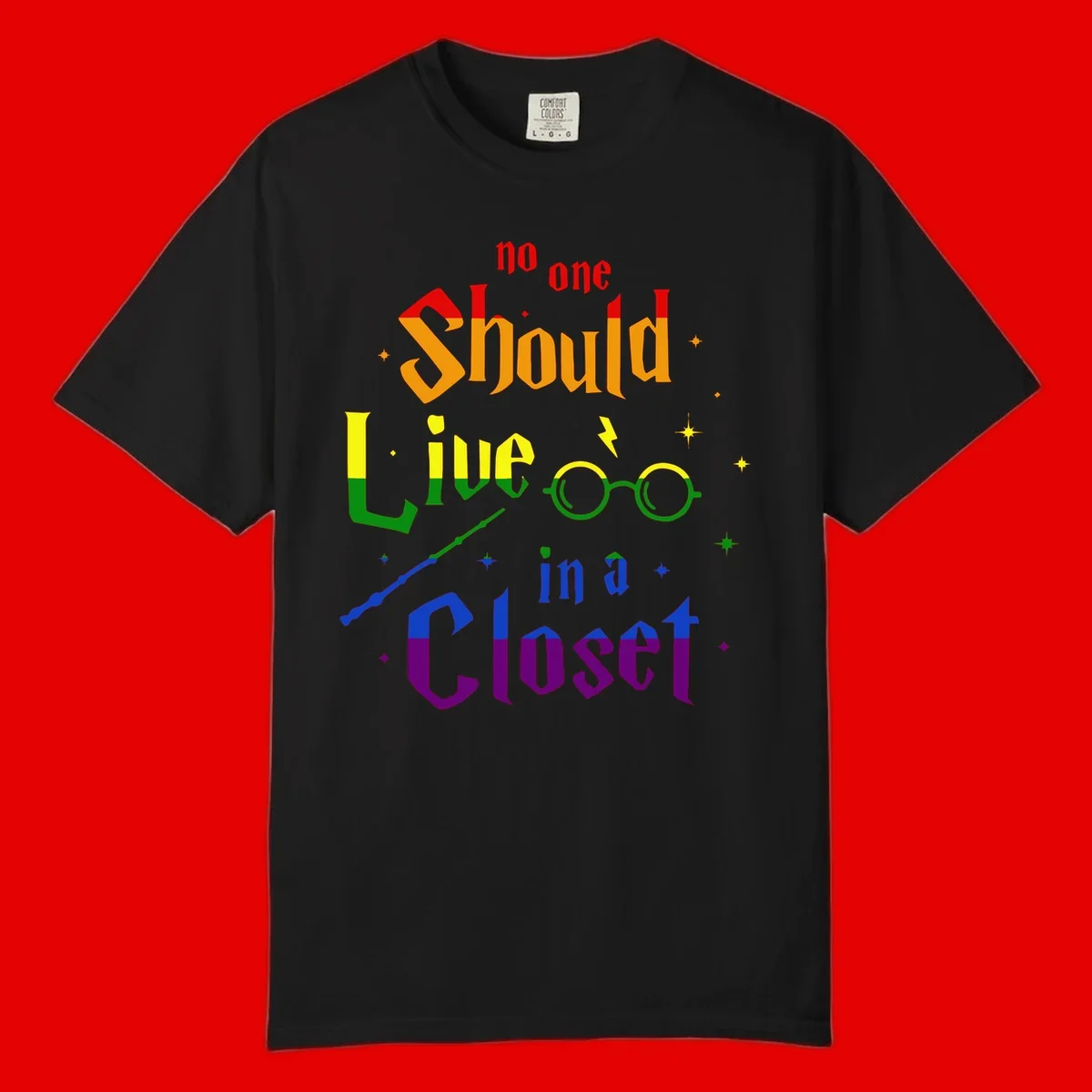 Rainbow gradient text reading 'no one Should live in a Closet' with magical elements including glasses, wand, and stars on gray background
