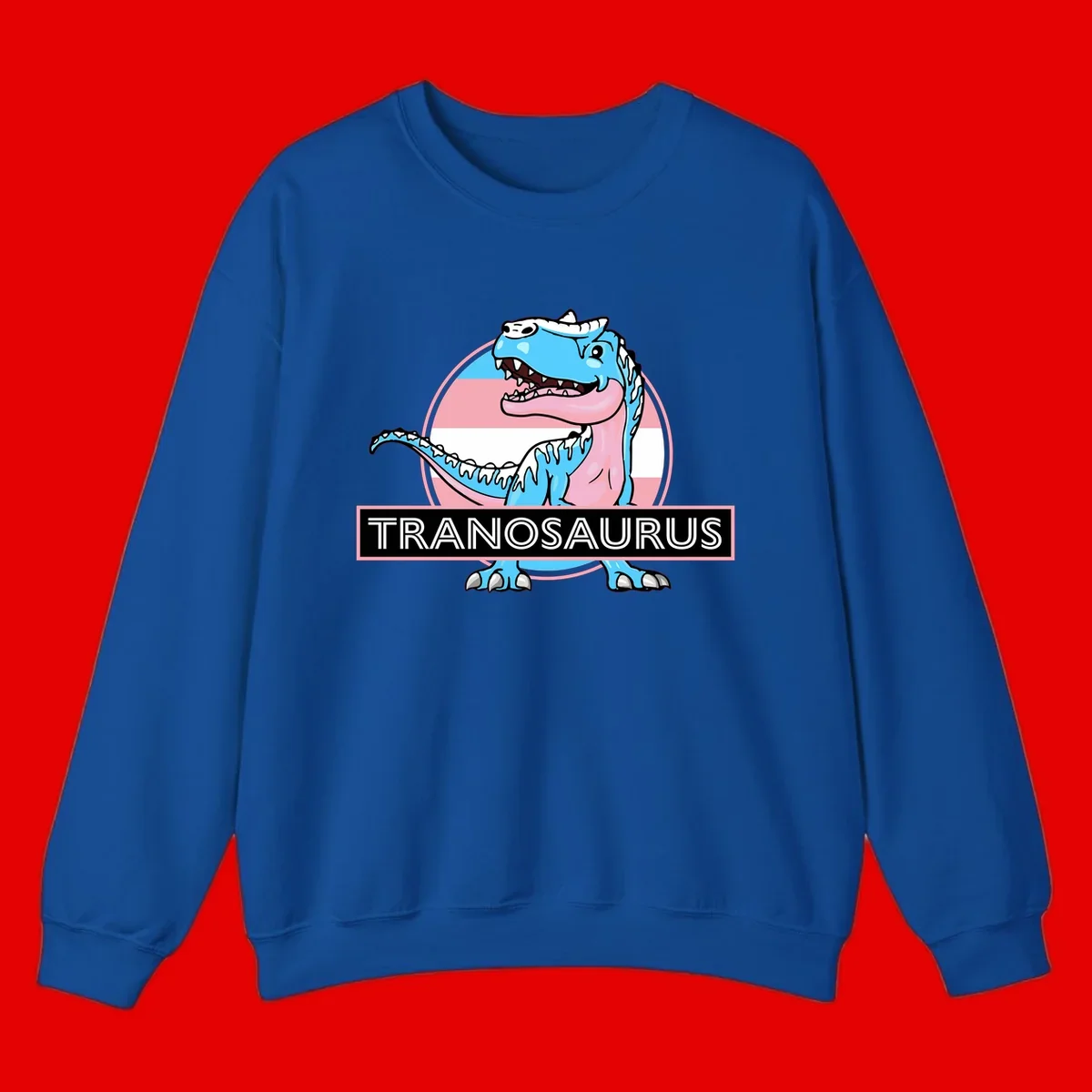 Blue cartoon T-Rex dinosaur with open mouth against pink and white pride flag circular background, labeled Tranosaurus