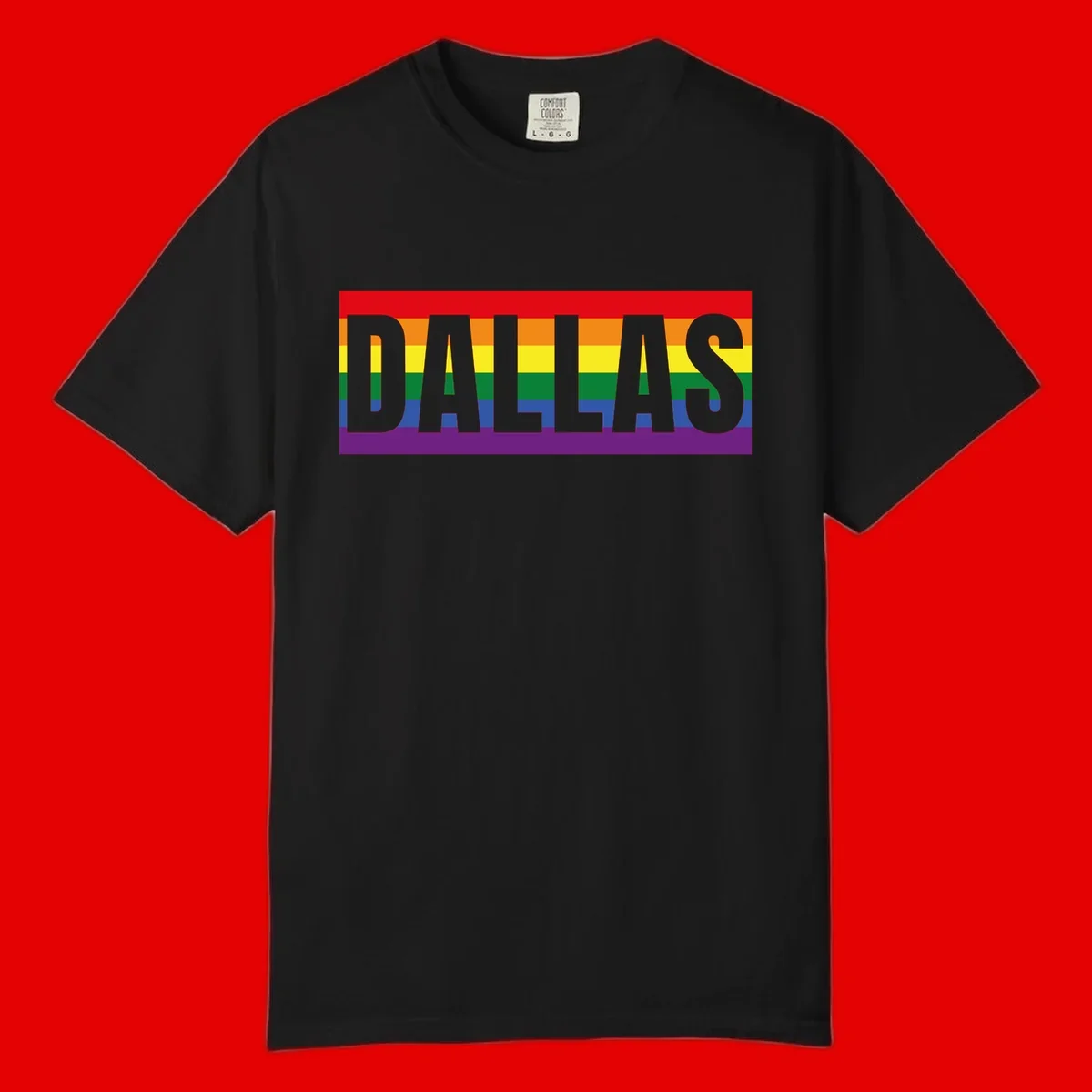 Gray DALLAS text overlaid on rainbow pride flag with red, orange, yellow, green, blue, and purple horizontal stripes