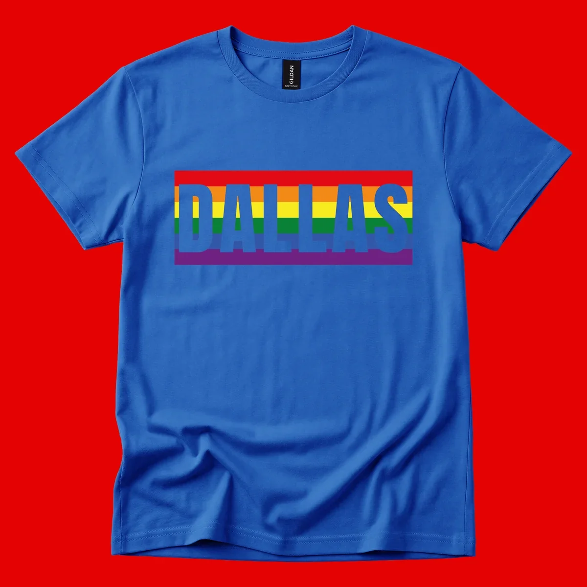 Gray DALLAS text overlaid on rainbow pride flag with red, orange, yellow, green, blue, and purple horizontal stripes