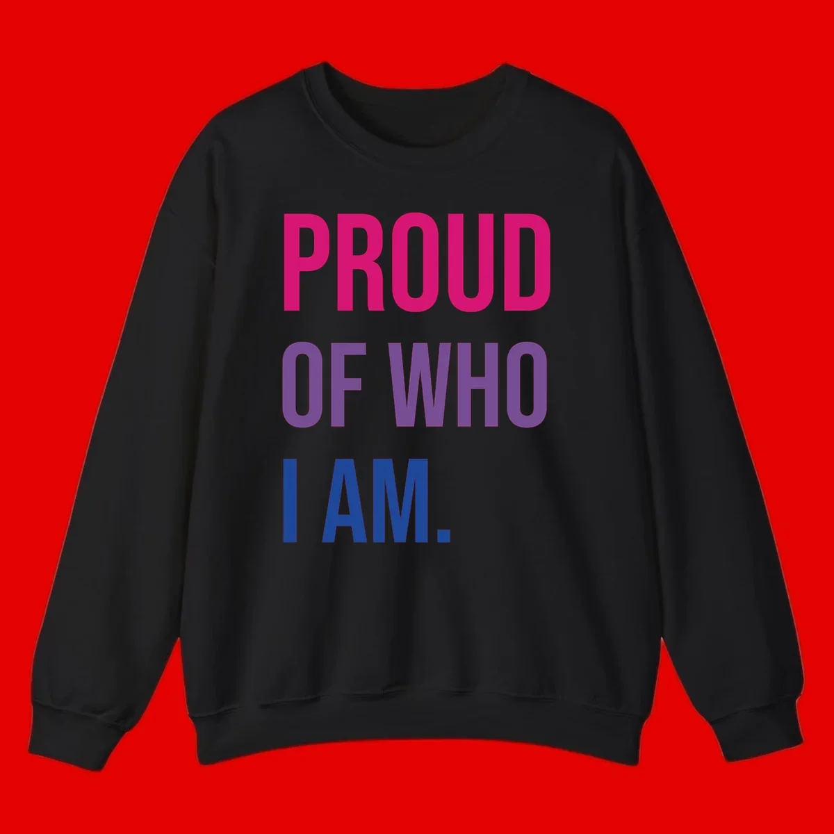 Bold colorful typography design reading 'PROUD OF WHO I AM' in magenta, purple, and blue letters on gray background