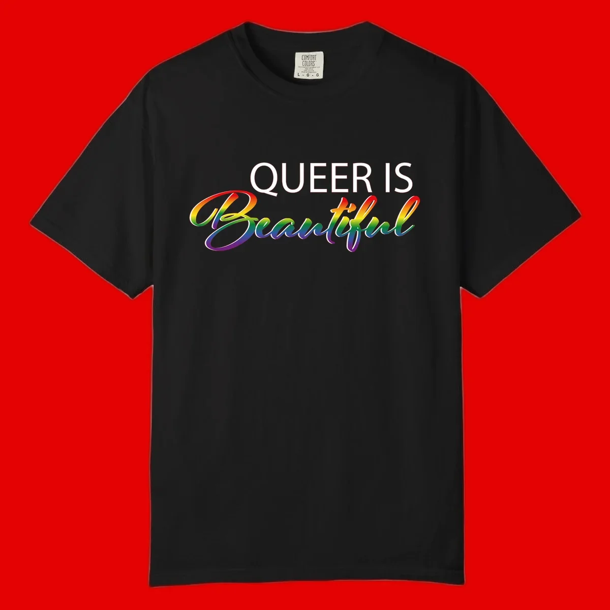 Rainbow gradient text reading 'Queer Is Beautiful' in pride flag colors on gray background