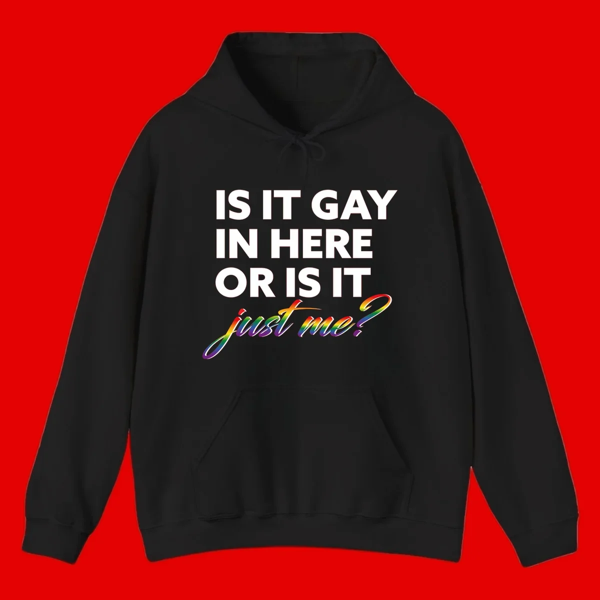 Bold white text reading "Is It Gay In Here Or Is It" with rainbow gradient lettering spelling "just me?" featuring pride flag colors on gray background