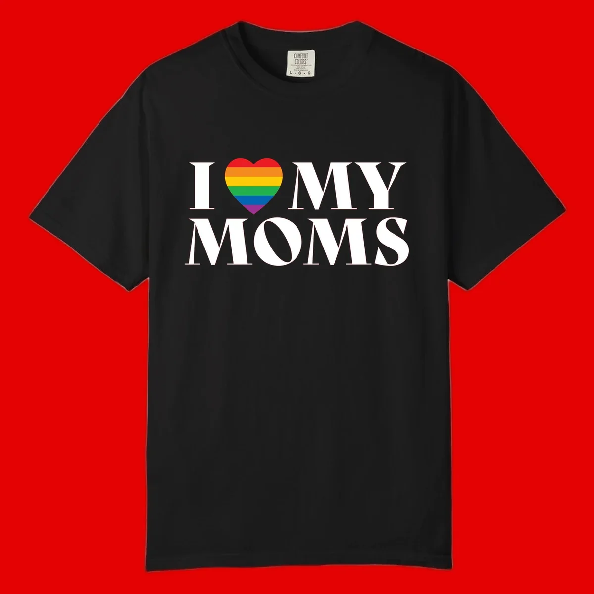 White text reading 'I love my moms' with a rainbow-striped heart symbol, celebrating LGBTQ+ family pride