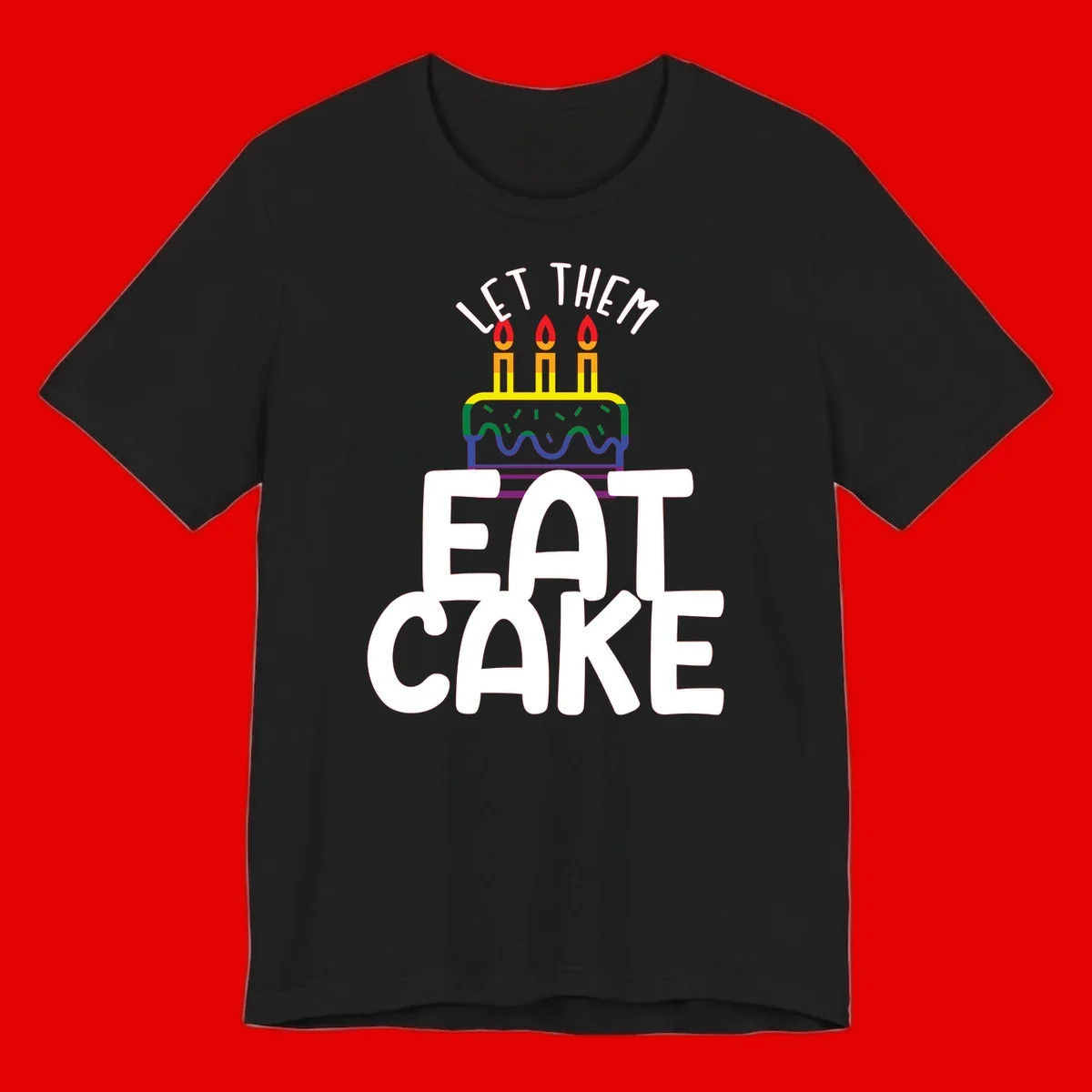 Rainbow-layered birthday cake with three candles above bold white text reading 'Let Them Eat Cake' - a Pride-themed design