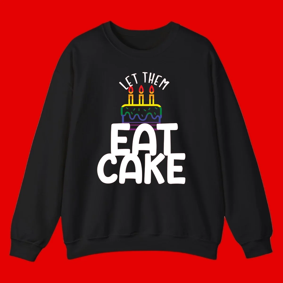 Rainbow-layered birthday cake with three candles above bold white text reading 'Let Them Eat Cake' - a Pride-themed design