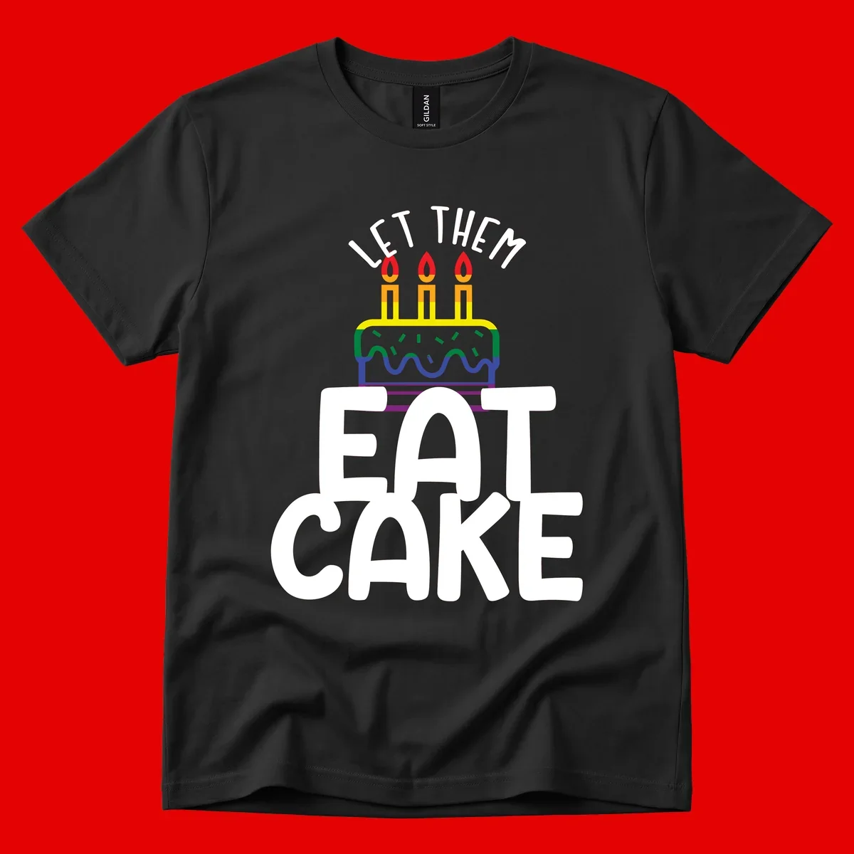 Rainbow-layered birthday cake with three candles above bold white text reading 'Let Them Eat Cake' - a Pride-themed design