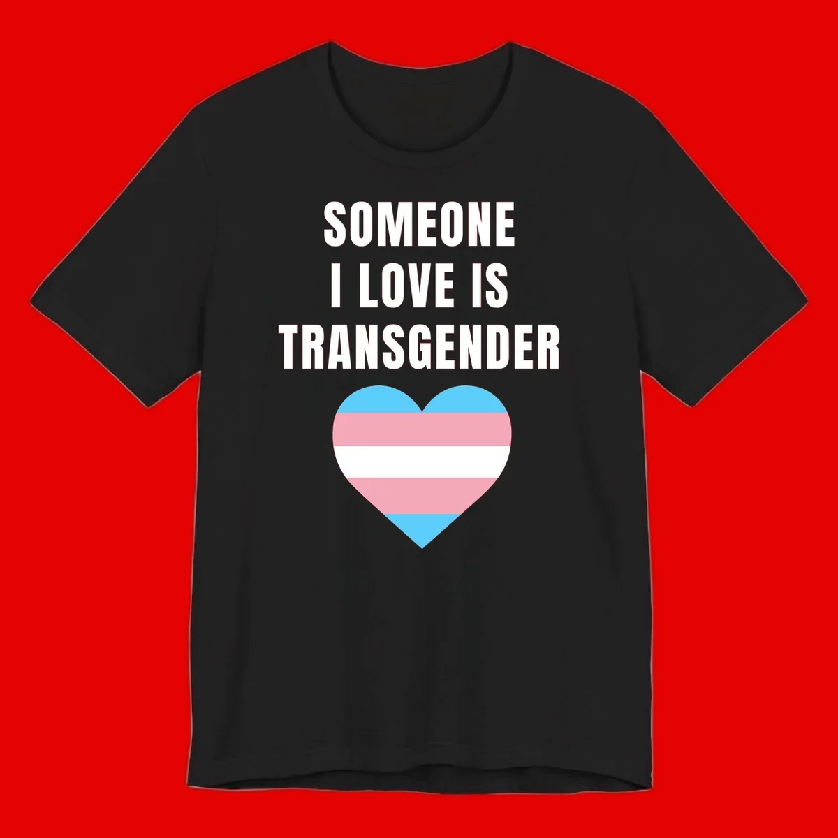 Gray background with white text reading 'Someone I Love Is Transgender' above a heart featuring blue, pink, and white transgender flag stripes